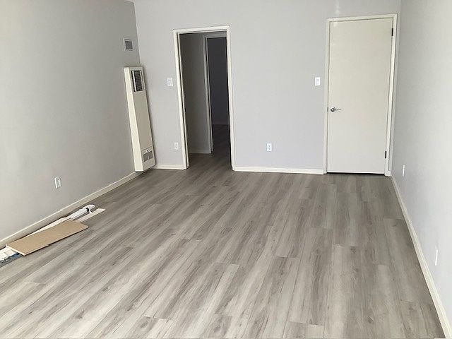 Living room from front door. Closet door on the right, hallway door on the left.