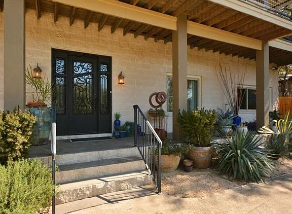 Gorgeous Iron door at inviting front entry.
