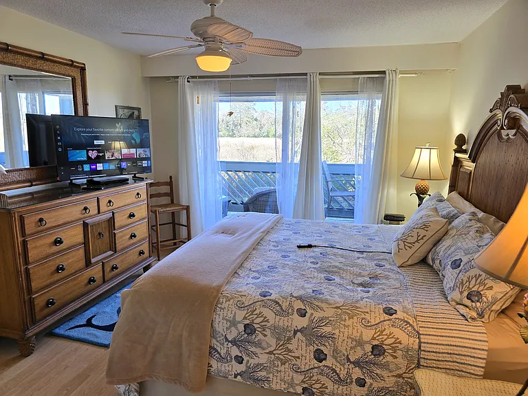 King size bed with a 43-inch Samsung smart TV, a marsh view with access to the deck and a remote controlled adjustable bed frame to raise your back.