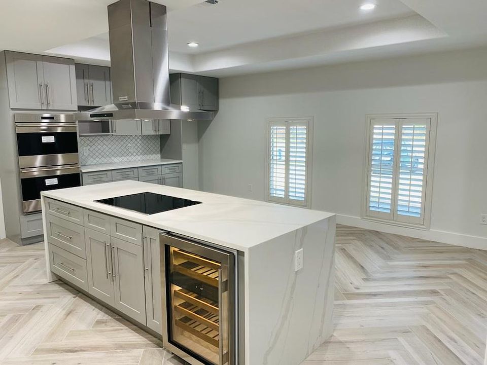 Open concept kitchen, gourmet appliances beautiful living room area.