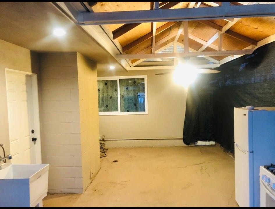 Private patio space. Small Sink, fridge, and stove provided. Fan ins_stales for some air and lighting. On the left is the door to the mast bedroom.