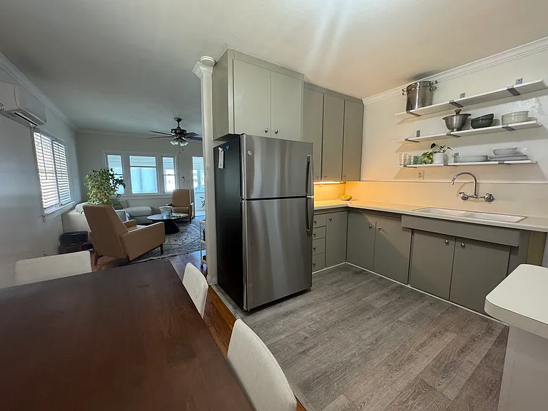 New, large stainless steel refrigerator with spacious freezer. Over counter lighting. Newly painted cabinets.
