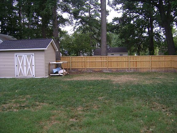 Custom built shed with privacy fence.