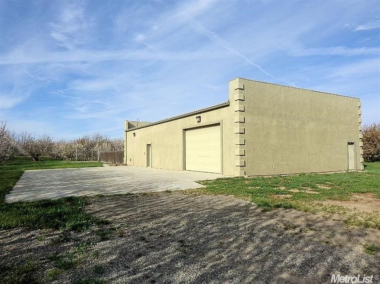 View of the building.  There is a roll up door in front and in back