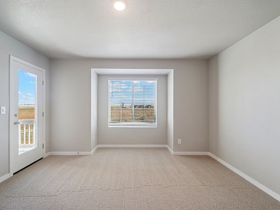 The master bedroom is spacious with a large window.