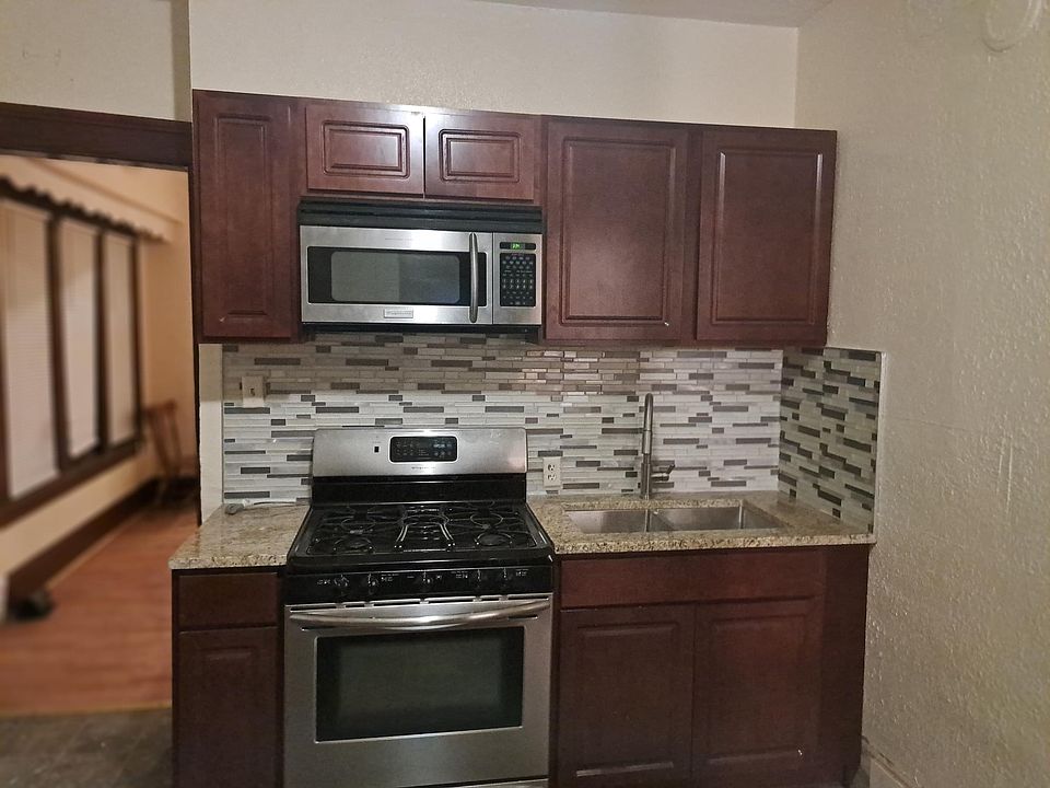 New cabinets, gas stove, microwave and sink with pull out faucet