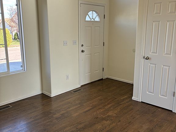 Front door and living room with solid hardwood floors