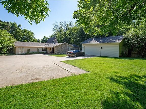 Front of home on large wooded 8/10 acre lot. Huge garage/shop, in-ground storm shelter, and lots of parking!