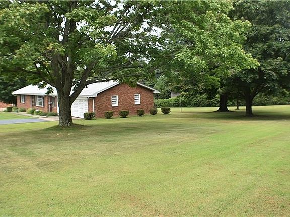 This side yard has so much space for your family activities. The shaded trees offer a park like setting.