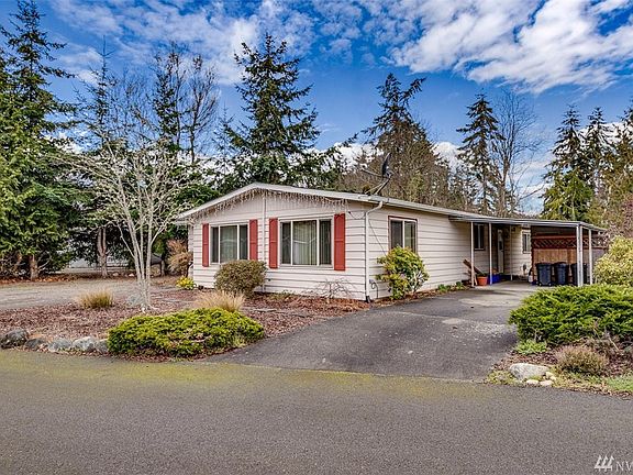 There is a single carport, plus room behind it to park another car.  There is also extensive parking space on the left side of the home.  The door off carport leads to utility room.  There is a storage shed at the back of the carport.