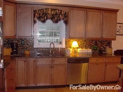 Kitchen
						:
						Solid maple cabinets with coffee glaze. Black granite countertops.