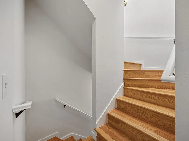 Stairs to ground floor garage, storage and laundry.