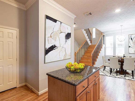 **Digitally Staged Photo of kitchen facing dining room.