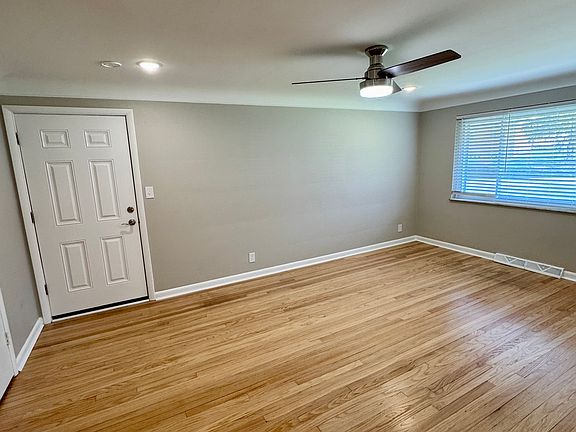 Living room features completely refinished genuine hardwood floors.