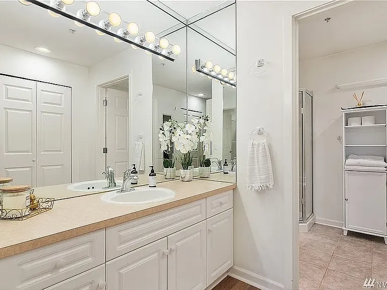 Primary bathroom; vanity separated from shower/tub/toilet