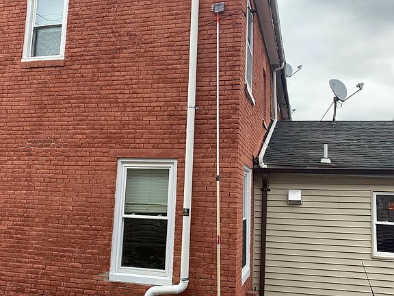 Outdoor view showing fresh paint. It is a corner house