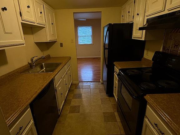 galley kitchen with opening to sitting room