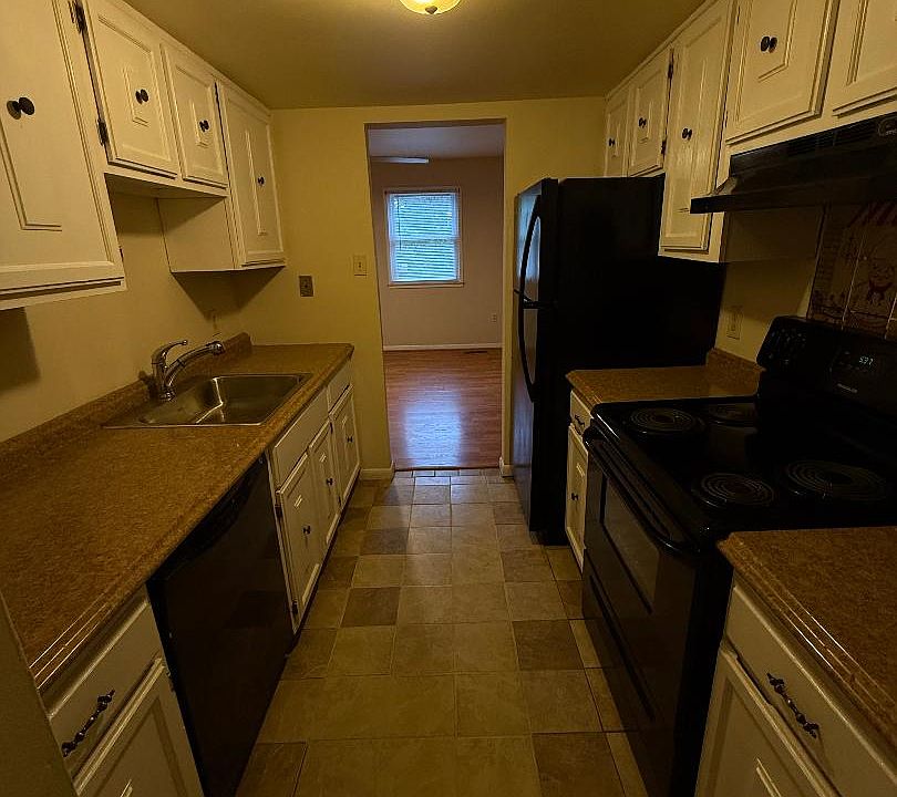 galley kitchen with opening to sitting room