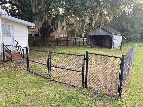 fenced in yard and storage shed