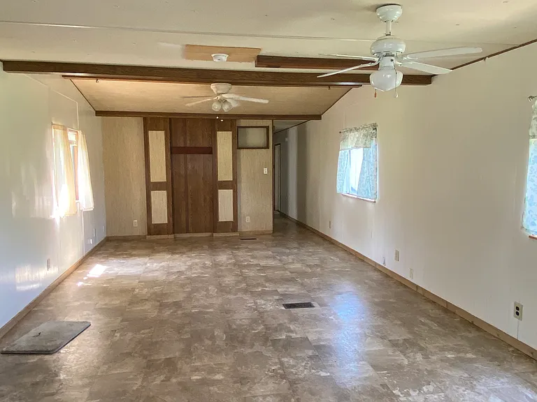 Large, open living room with accent wall for entertainment center or TV mount.