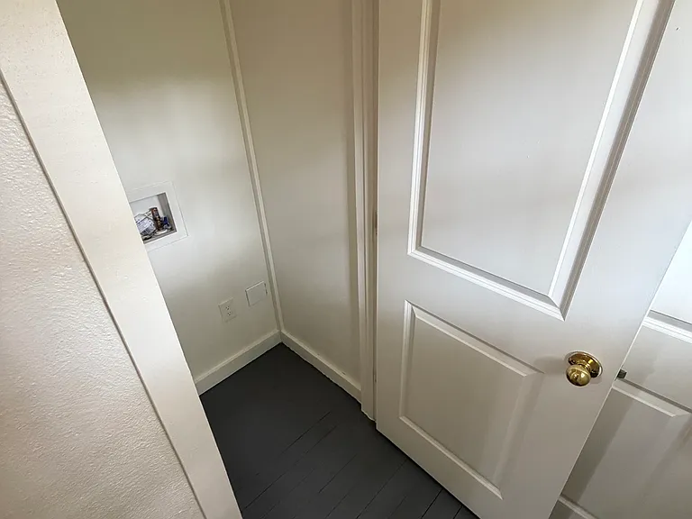 Utility closet in hallway to garage