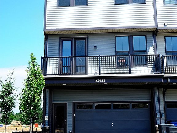 Back View with Balcony, Two Car Garage, and Driveway Parking