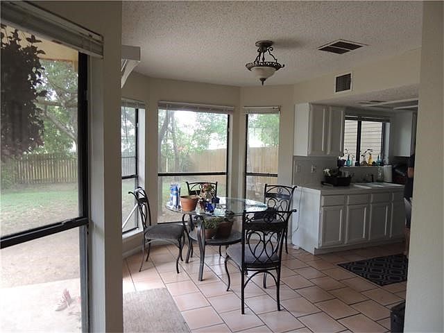 Breakfast area looks out to covered patio and back lawn.