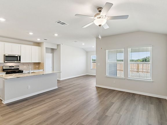 The kitchen, living, and dining areas are great for bringing together family and friends.