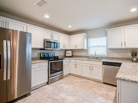 Gourmet kitchen with granite, soft-close cabinets,