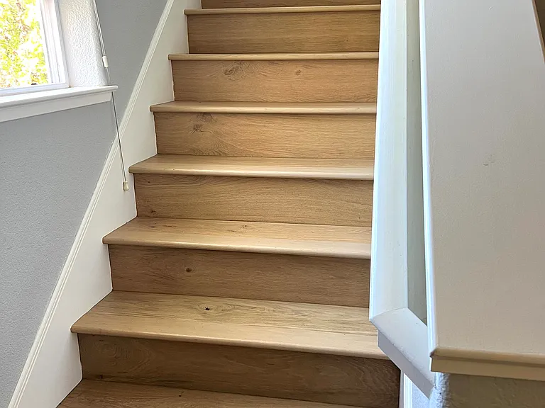 Stairs leading up to all bedrooms and 2 of the bathrooms