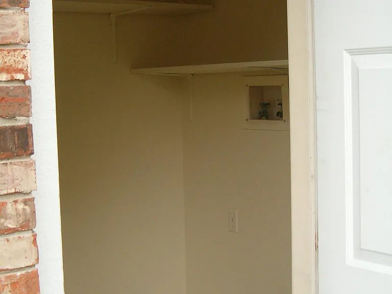 Storage room with washer and dryer connections