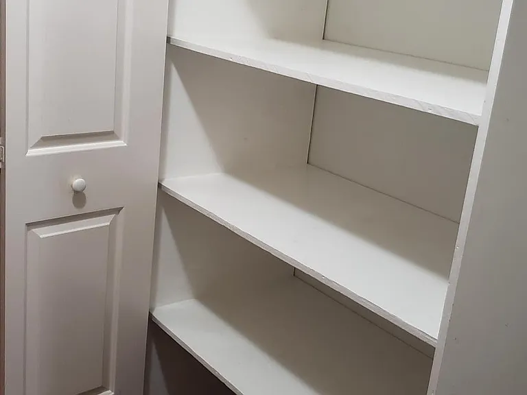 Huge storage closet with built in shelves in laundry room