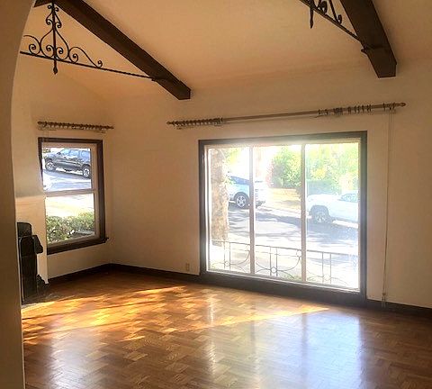 Living room with open beam ceiling.