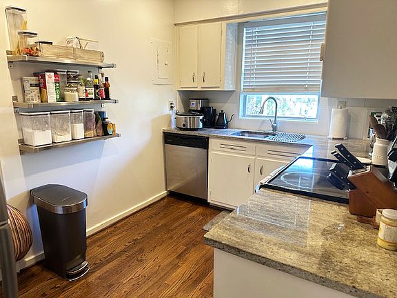 Kitchen with lots and storage and also open stainless shelves.