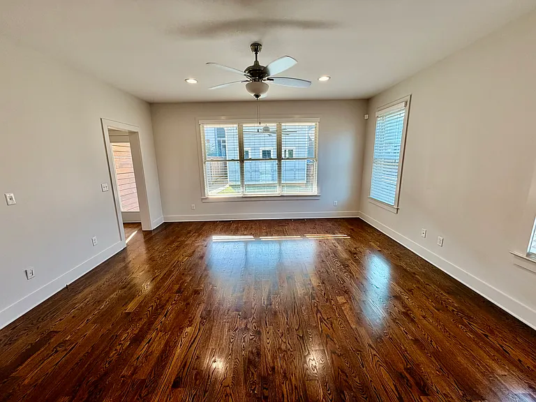 View opens to a private, fenced-in, grass yard and the two car garage