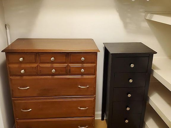 Bedroom includes large walk-in closet with dressers