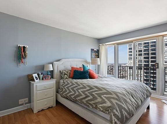 Bedroom ***now painted neutral grey/beige*** with glimpse of second balcony
