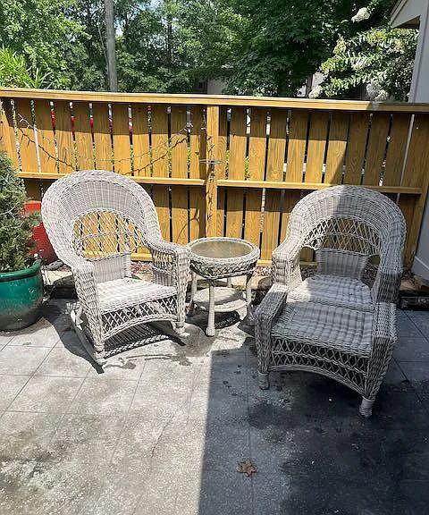 Photo isn't the most inviting, but that will change. There is a fenced patio off the living room that allows for private seating and enjoyment of the great weather here. There is patio furniture and soft exterior lighting to make sure you are comfortabl
