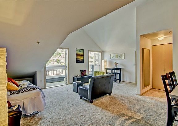 Two sets of French doors lead to a private deck with Space Needl