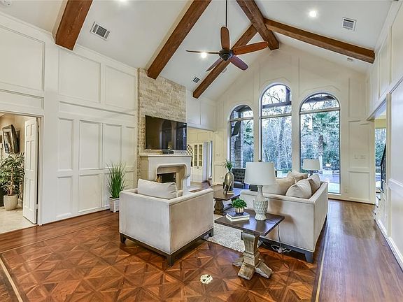 Shared stone fireplace from Family room with Den which has stunning wet bar and glass front cabinets
