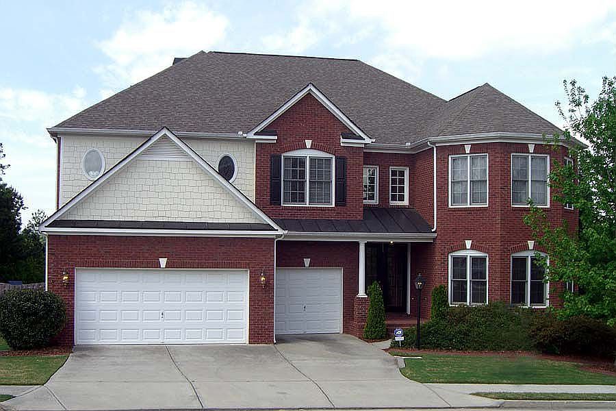 Brick home with finished terr lvl & 3-car garage & you can't beat the location