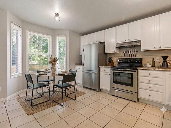 Kitchen with newer appliances (stove, refrigerator, dishwasher included). (Furnishings for illustrative purposes only, not included.)