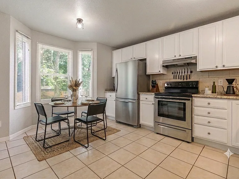 Kitchen with newer appliances (stove, refrigerator, dishwasher included). (Furnishings for illustrative purposes only, not included.)