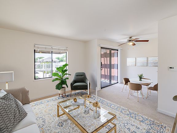 Inviting living space with defined dining area and natural light perfect for relaxing or entertaining.