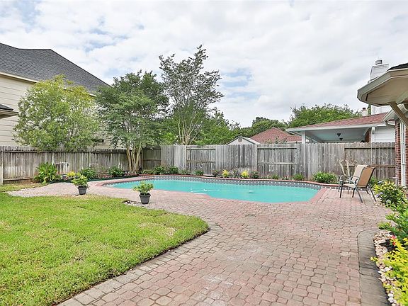 BACK YARD - In addition to the pool, there is grassy space for kids and pets to enjoy.