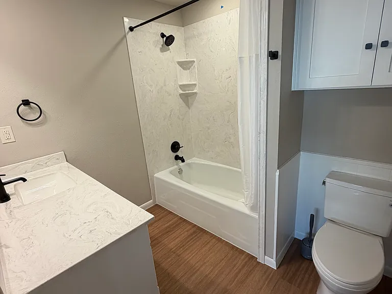 Alpine private bath with Cultured marble shower and countertop. All new fixtures, new custom cabinets, electrical and plumbing.