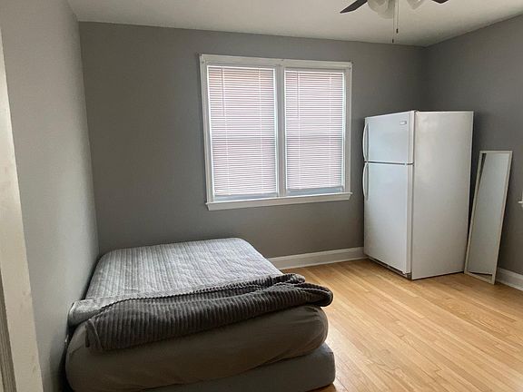Bedroom 1 (Main Floor). Room comes with a full-size fridge that may be moved if requested.