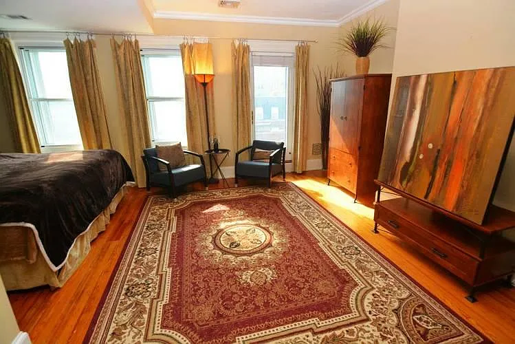 3rd floor Room C sitting area. Artwork is replaced by a 50-inch tv. Wardrobe has been removed. Use walk-in closet outside room instead.