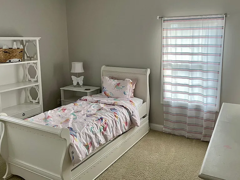 Spacious secondary bedroom with abundant natural light and generous closet space