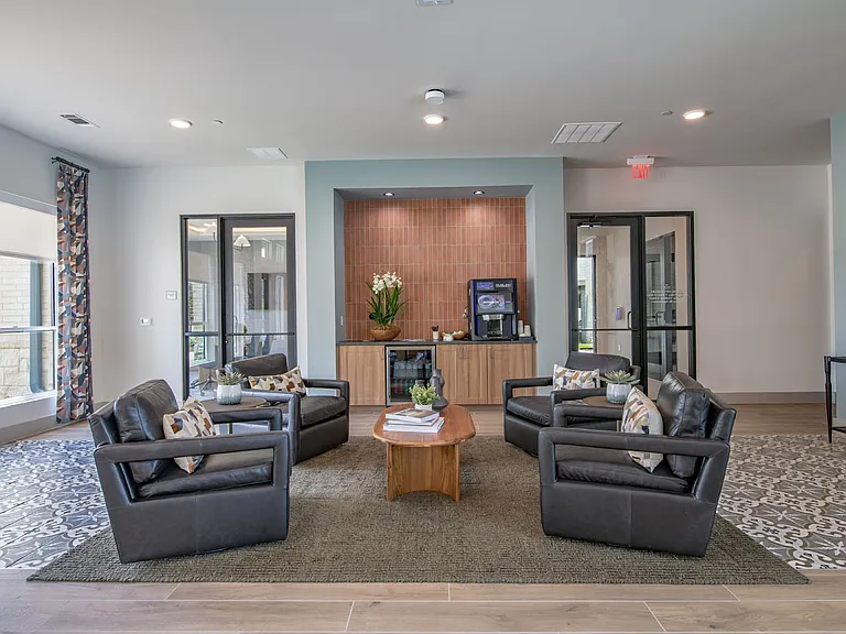 Step into the inviting lounge at Sage at Celina Residences, where modern design meets comfort. Relax in stylish seating or connect with neighbors in this vibrant space. Don't miss out on your chance to call this community home; schedule a visit today!
